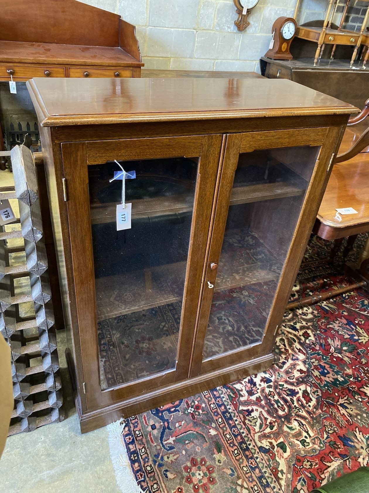 An early 20th century glazed mahogany two door bookcase, width 79cm, depth 33cm, height 109cm